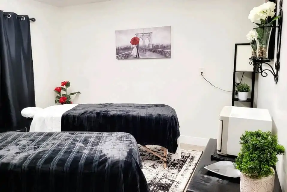 Couples massage room with two treatment beds at Safe Haven Spa