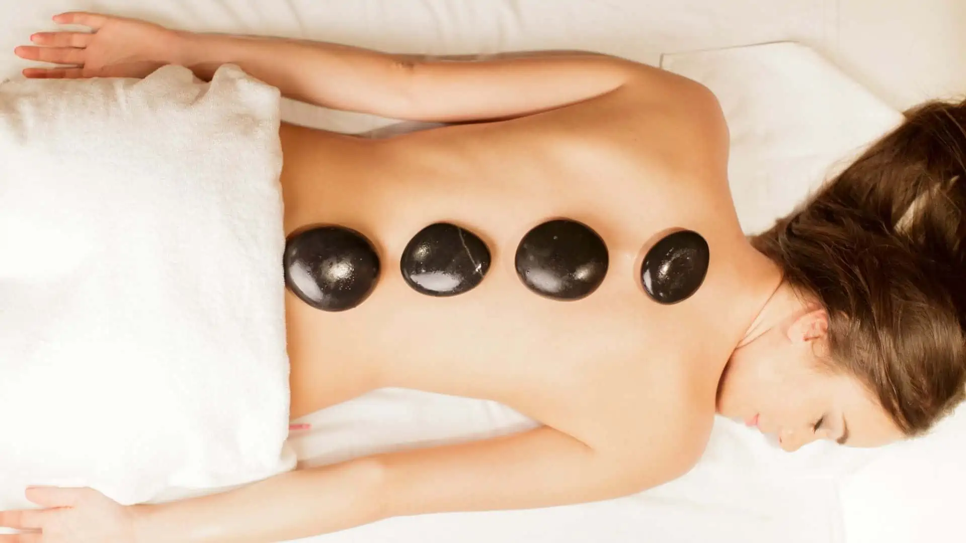 Hot stone massage with heated volcanic basalt stones at Safe Haven Spa