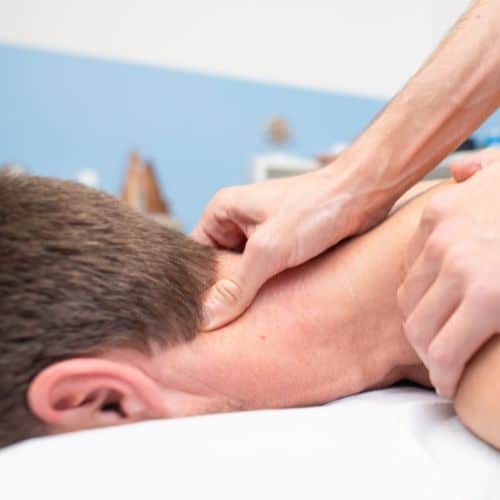 man facing down having neck massage